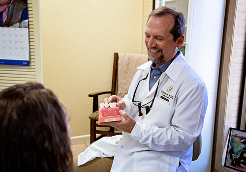 Dr. Butler laughing with dental patient