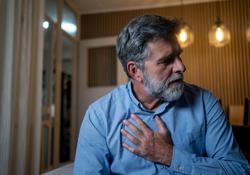 Concerned man touching his heart