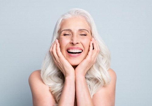 a patient smiling during dental implant consultation in Lexington