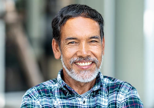 Man sharing smile after fixed bridge tooth replacement