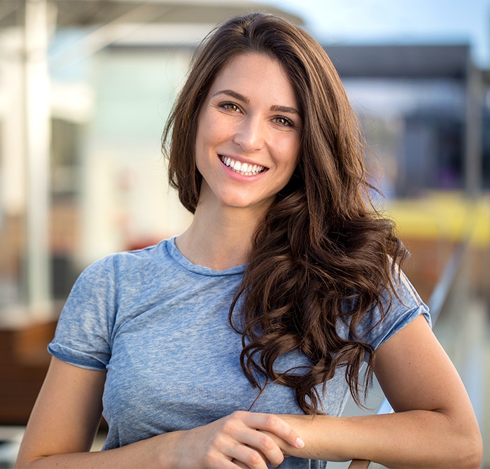 Woman sharing healthy smile after dental checkup and teeth cleaning