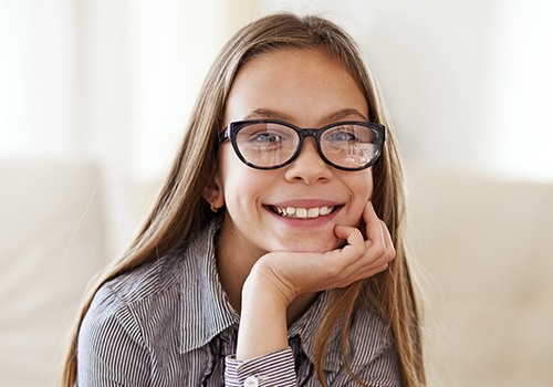 Young girl with healthy smile thanks to silver diamine fluoride treatment