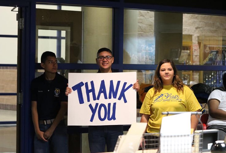 Dental patient holding up thank you sign