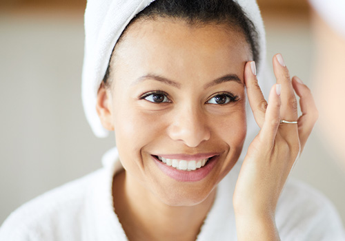 Woman looking at smile after teeth whitening