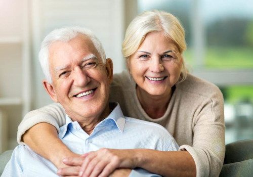 Smiling older couple pleased with their dental crowns