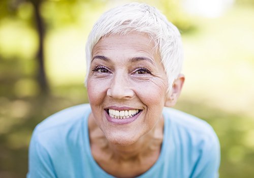 Woman sharing her beautiful new dentures