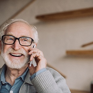 Senior man with glasses talking on the phone