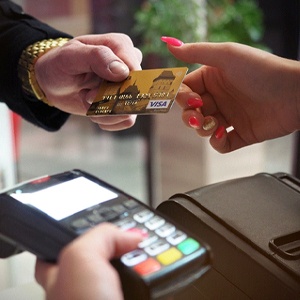 Man handing woman credit card