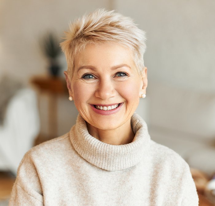 Woman sharing smile after full mouth rehabilitation