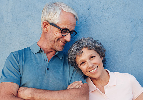 Older man and woman sharing smiles after full rehabilitation treatments