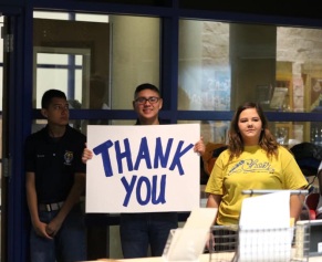 Dental team holding thank you sign for patients