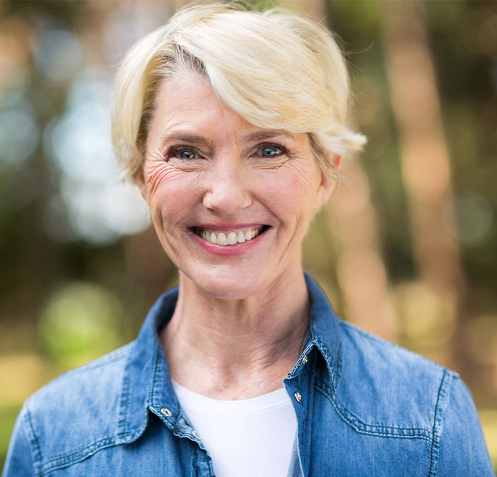 Older woman sharing smile after replacing missing teeth