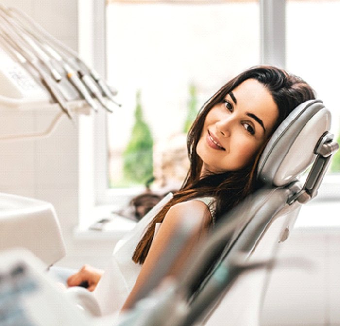 Relaxed woman smiling at the dentist