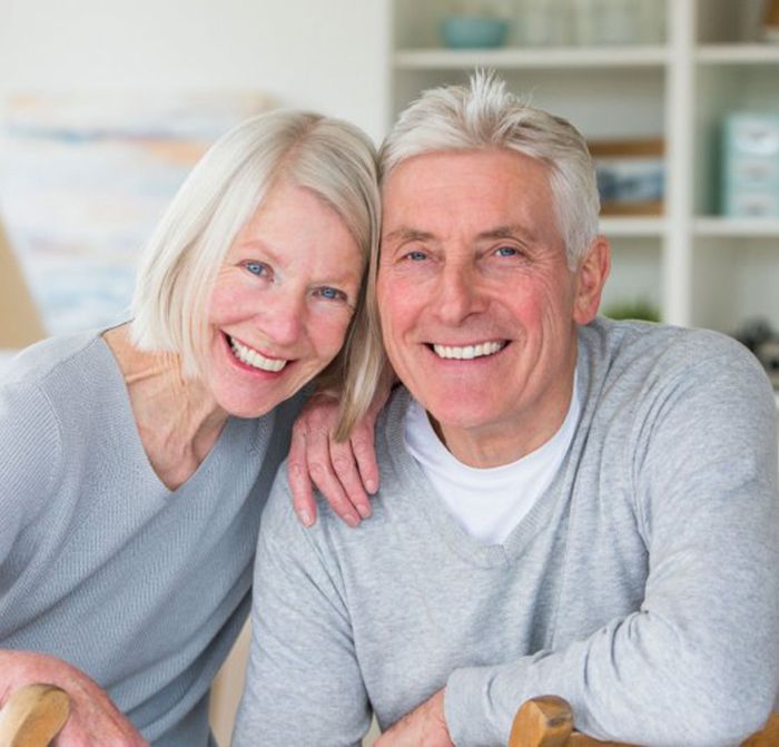 elderly couple smiling after getting scaling and root planing in Kerrville