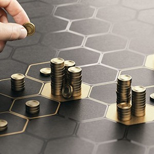 Hand arranges coins on hexagonal grid