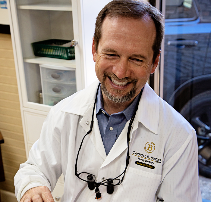 Dr. Butler laughing with dental patient