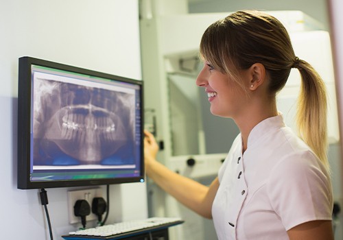 Dental team member looking at digital x-rays