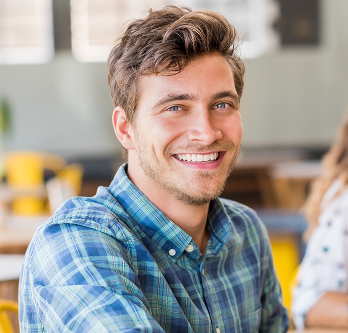 Man sharing flawless smile after porcelain veneers