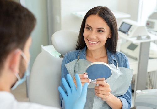 Patient smiling at dentist during initial consultation