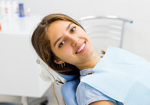 Woman in dental chair for in-office teeth whitening