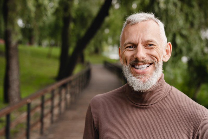 mature man smiling after visiting a cosmetic dentist in Kerrville