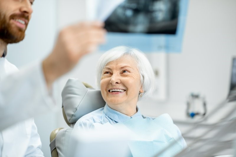 patient receiving dentures from dentist