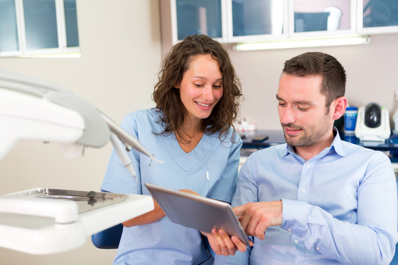 Patient talking to dentist at dental checkup