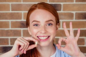 Woman smiling after getting her tooth pulled